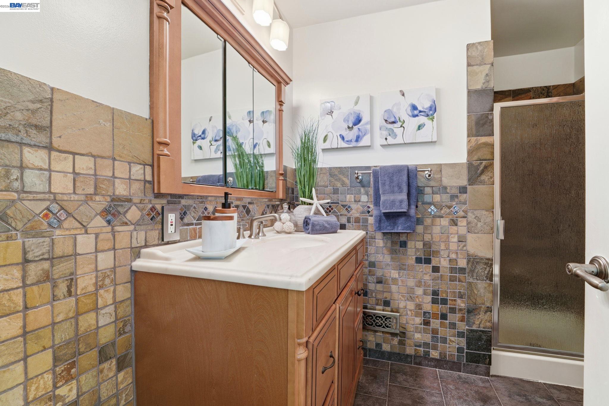 38524 Burdette Common Fremont, CA 94536 - Photo 23 of 35 a bathroom with a sink mirror and a shower