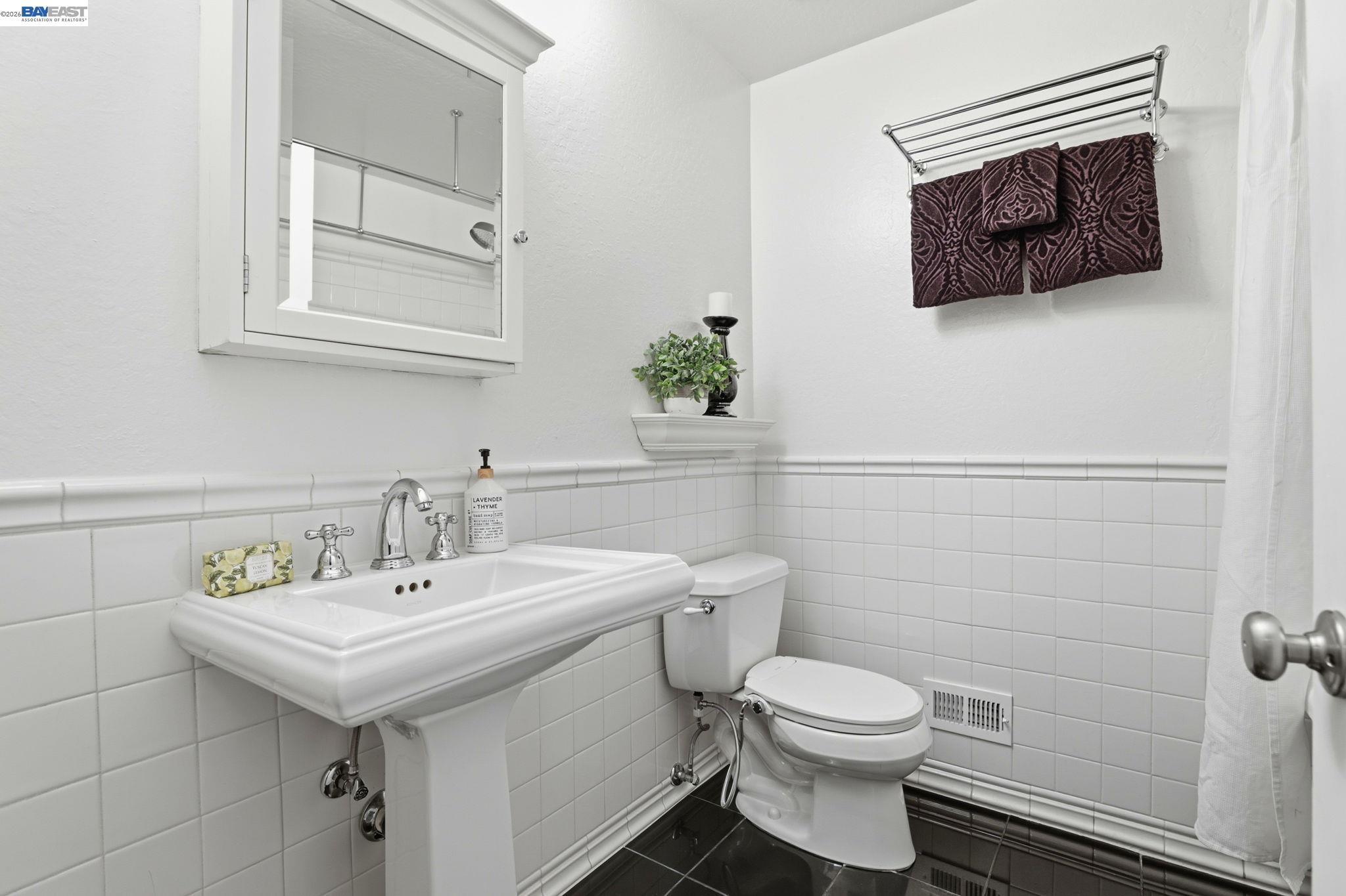 38524 Burdette Common Fremont, CA 94536 - Photo 25 of 35 a bathroom with a sink a mirror and a toilet