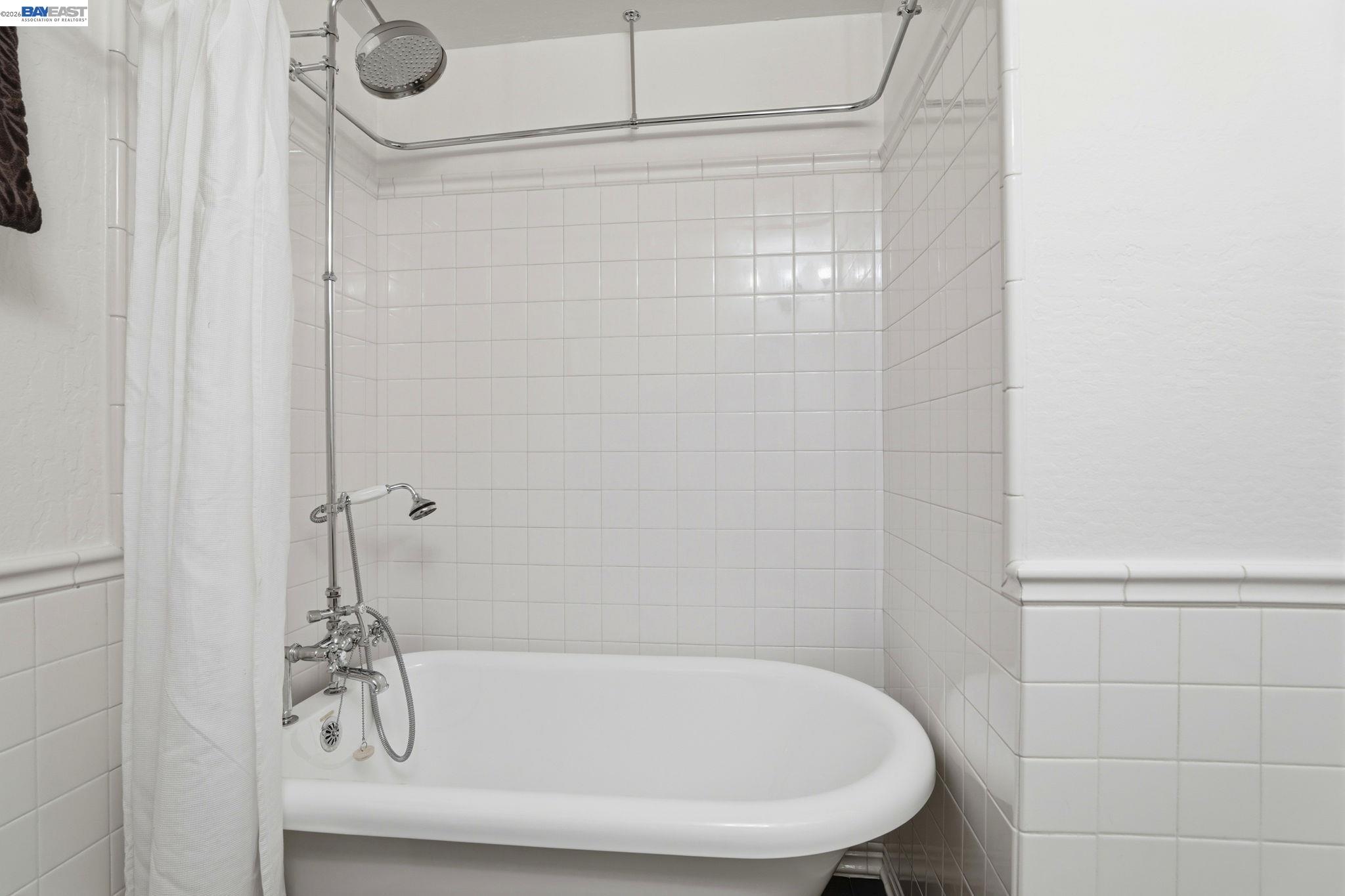 38524 Burdette Common Fremont, CA 94536 - Photo 26 of 35 a bathroom with a white bath tub and a shower