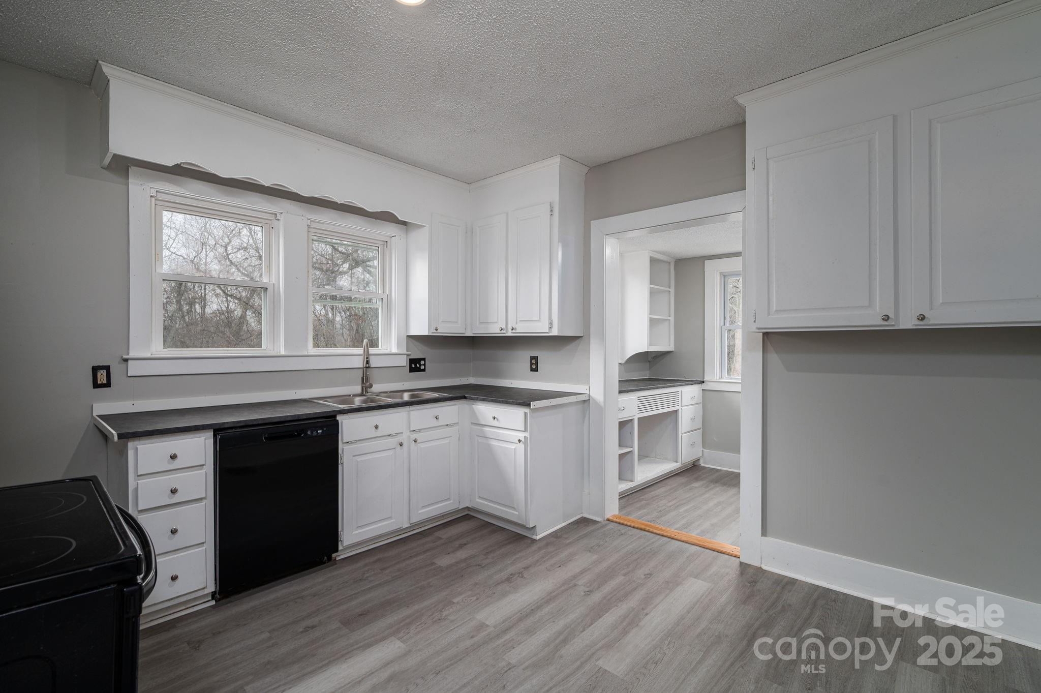 2645 Kool Park Road Northeast Hickory, NC 28601 - Photo 12 of 46 a kitchen with granite countertop white cabinets and wooden floor