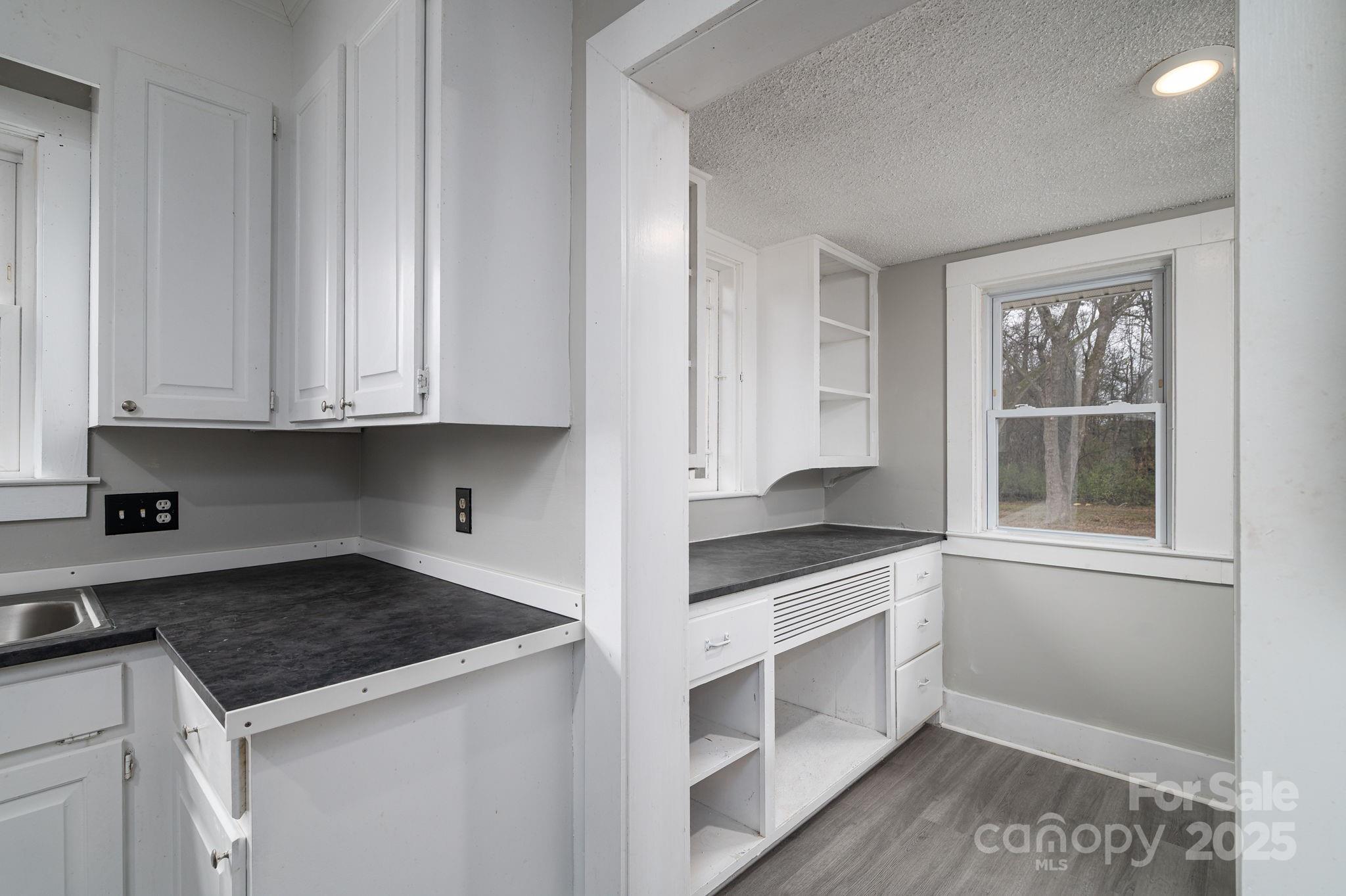 2645 Kool Park Road Northeast Hickory, NC 28601 - Photo 14 of 46 a kitchen with granite countertop white cabinets and white appliances