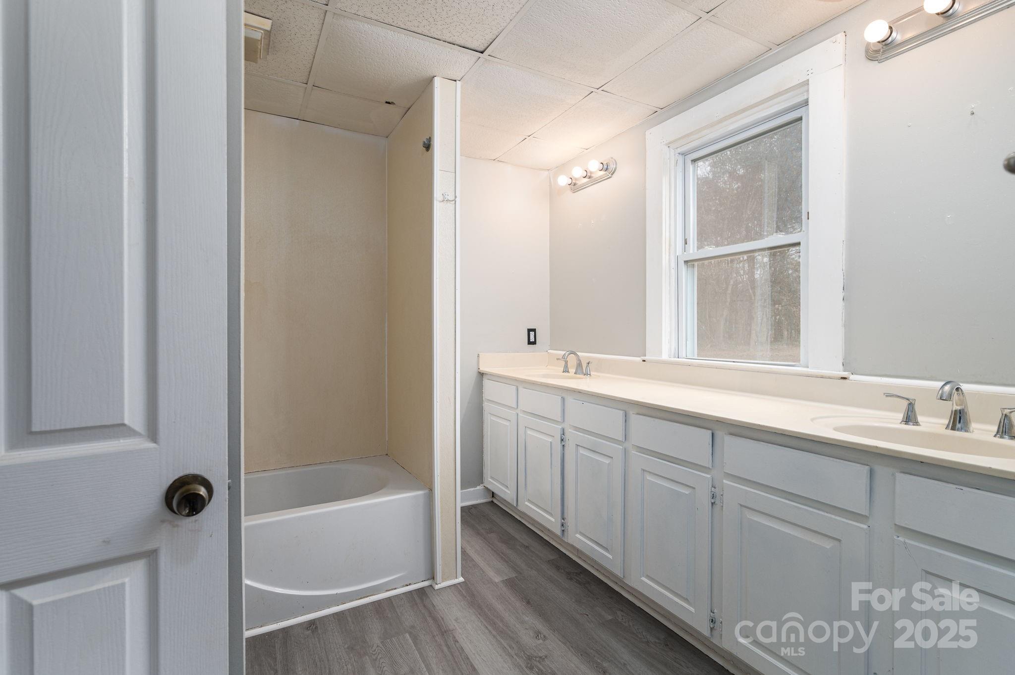 2645 Kool Park Road Northeast Hickory, NC 28601 - Photo 17 of 46 a bathroom with a double vanity sink and a bathtub