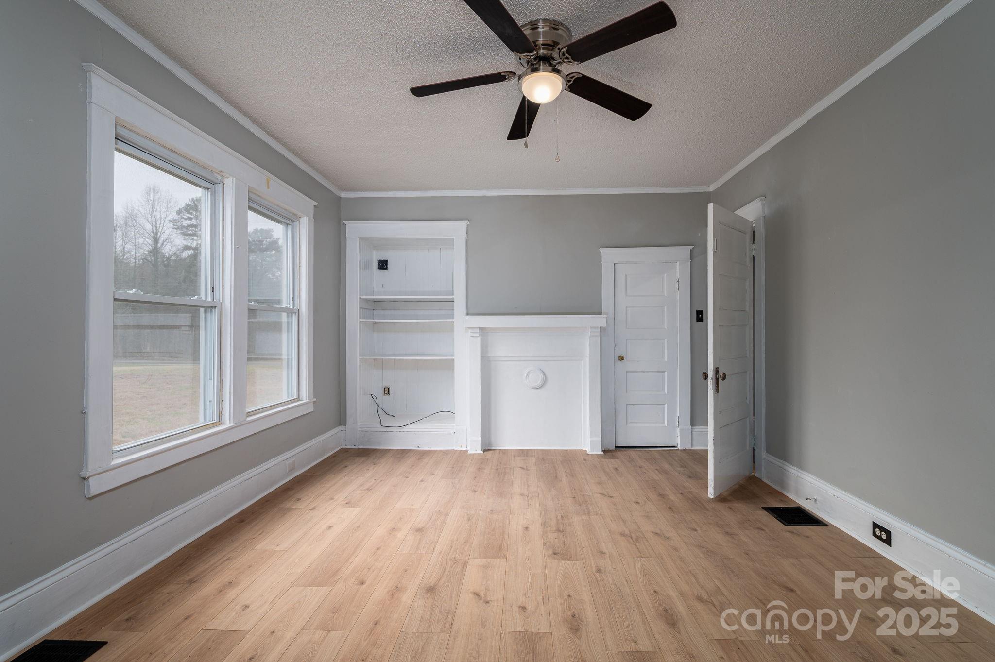 2645 Kool Park Road Northeast Hickory, NC 28601 - Photo 19 of 46 a view of empty room with wooden floor and fan