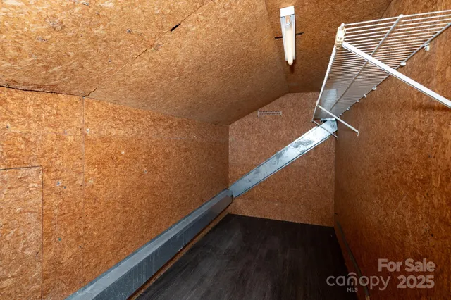 a view of a house with a large window and wooden fence