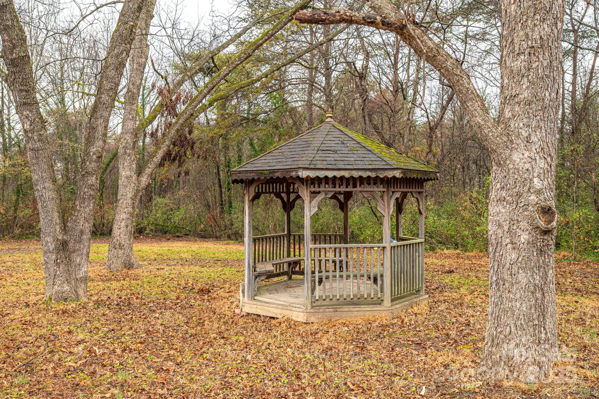 2645 Kool Park Road Northeast Hickory, NC 28601 - Photo 35 of 46 a view of a small house with large trees and a small yard