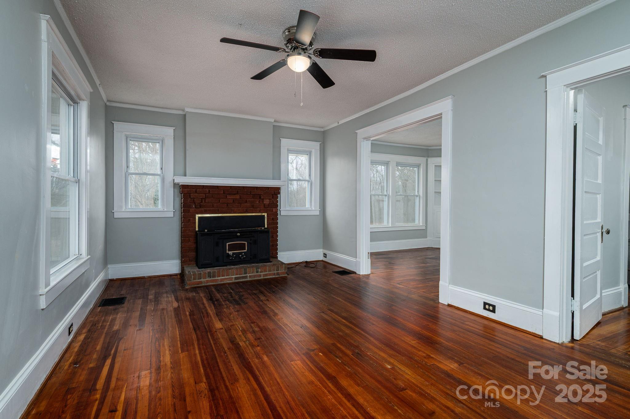 2645 Kool Park Road Northeast Hickory, NC 28601 - Photo 7 of 46 a view of an empty room with wooden floor fireplace and a window