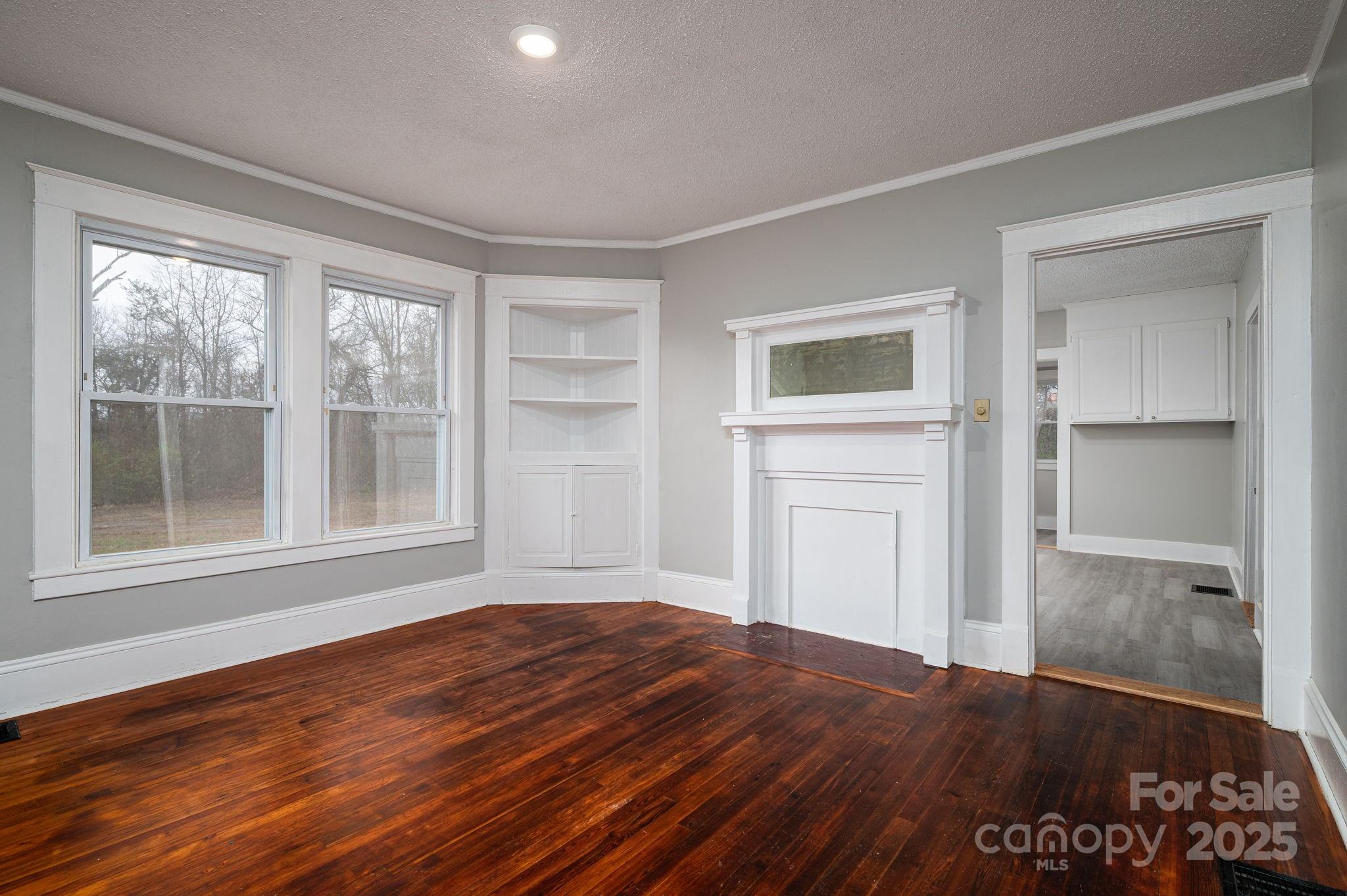2645 Kool Park Road Northeast Hickory, NC 28601 - Photo 10 of 46 a view of an empty room with a window and wooden floor