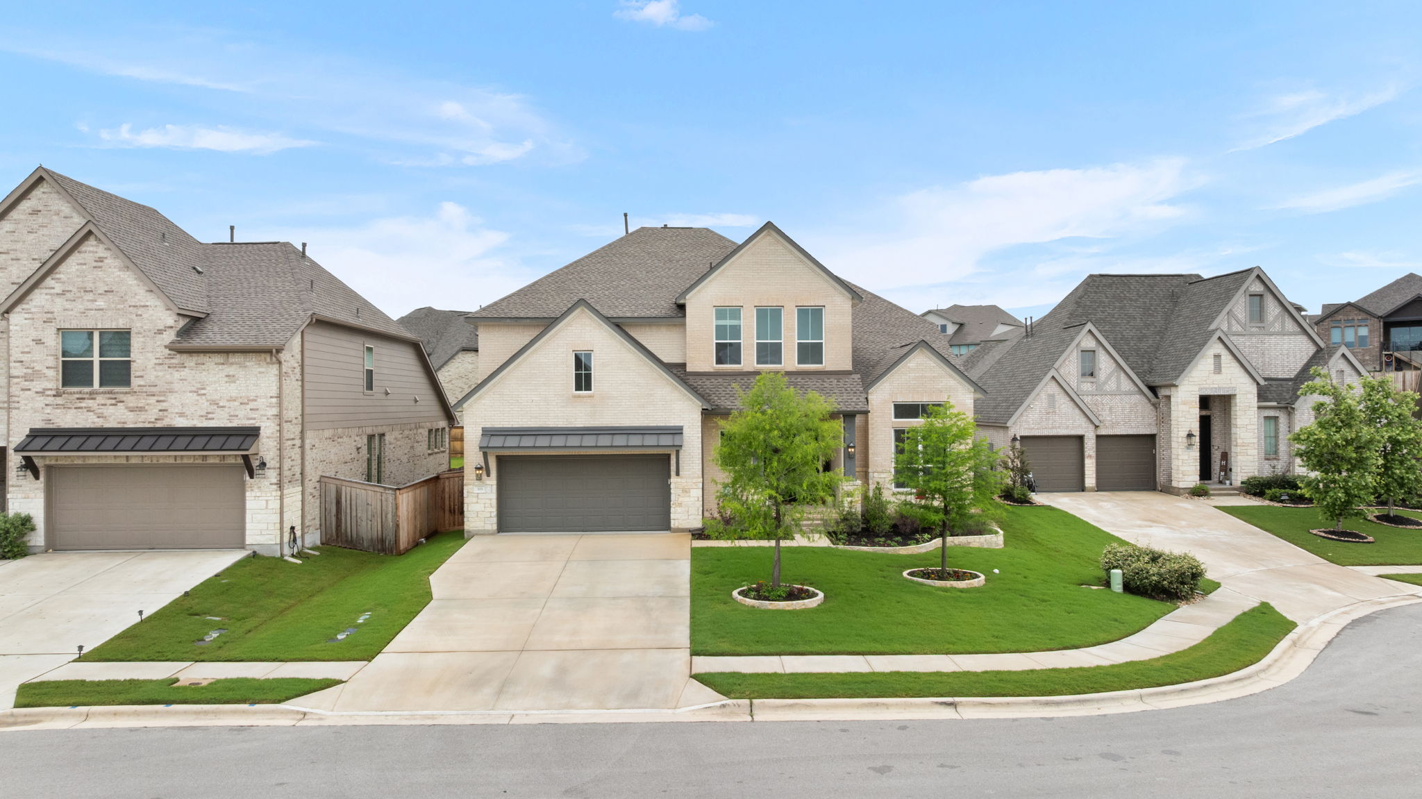 515 Watershield Cove Georgetown, TX 78633 - Photo 37 of 40 Elegant brick and stone facade adorns this residence with a well-maintained lawn.