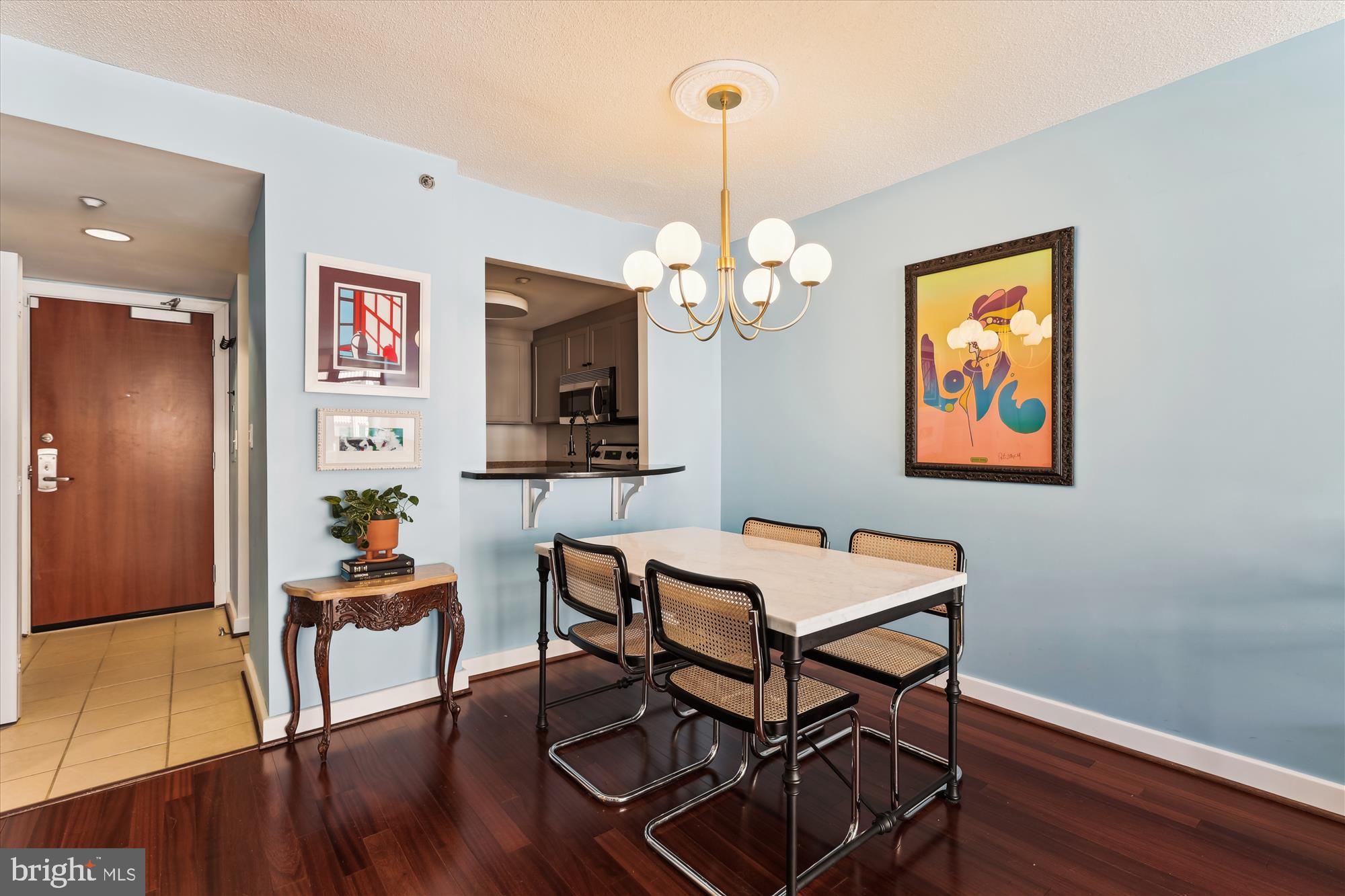1150 K Street Northwest, Unit 706 Washington, DC 20005 - Photo 13 of 34 a view of a dining room with furniture a chandelier and wooden floor