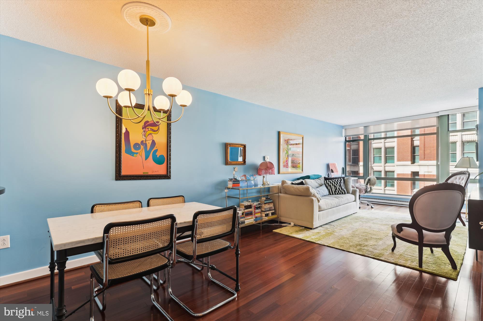 1150 K Street Northwest, Unit 706 Washington, DC 20005 - Photo 14 of 34 a view of a dining room with furniture a chandelier and wooden floor