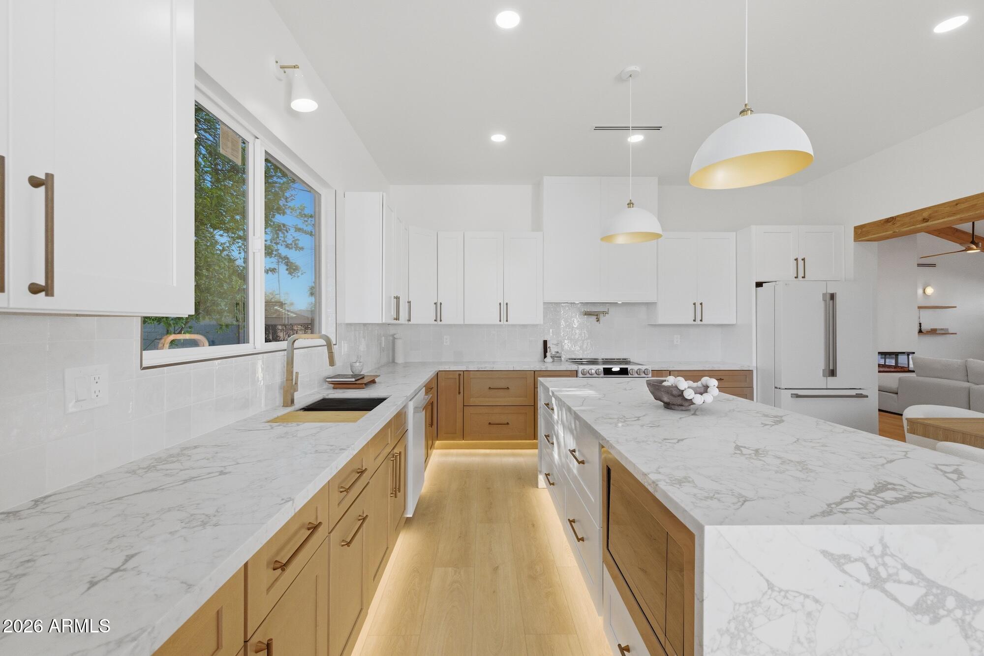 333 West Seldon Lane Phoenix, AZ 85021 - Photo 20 of 73 a kitchen with a stove a sink a center island and windows