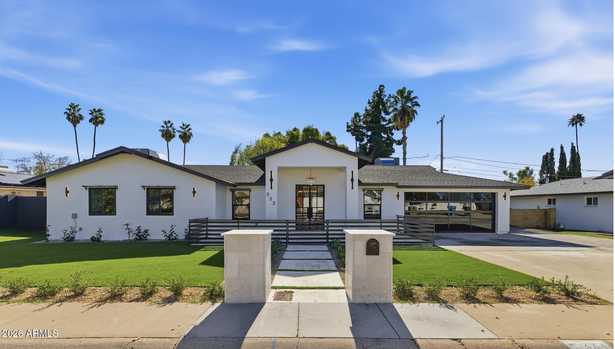 333 West Seldon Lane Phoenix, AZ 85021 - Photo 2 of 73 a front view of a house with a garden and plants
