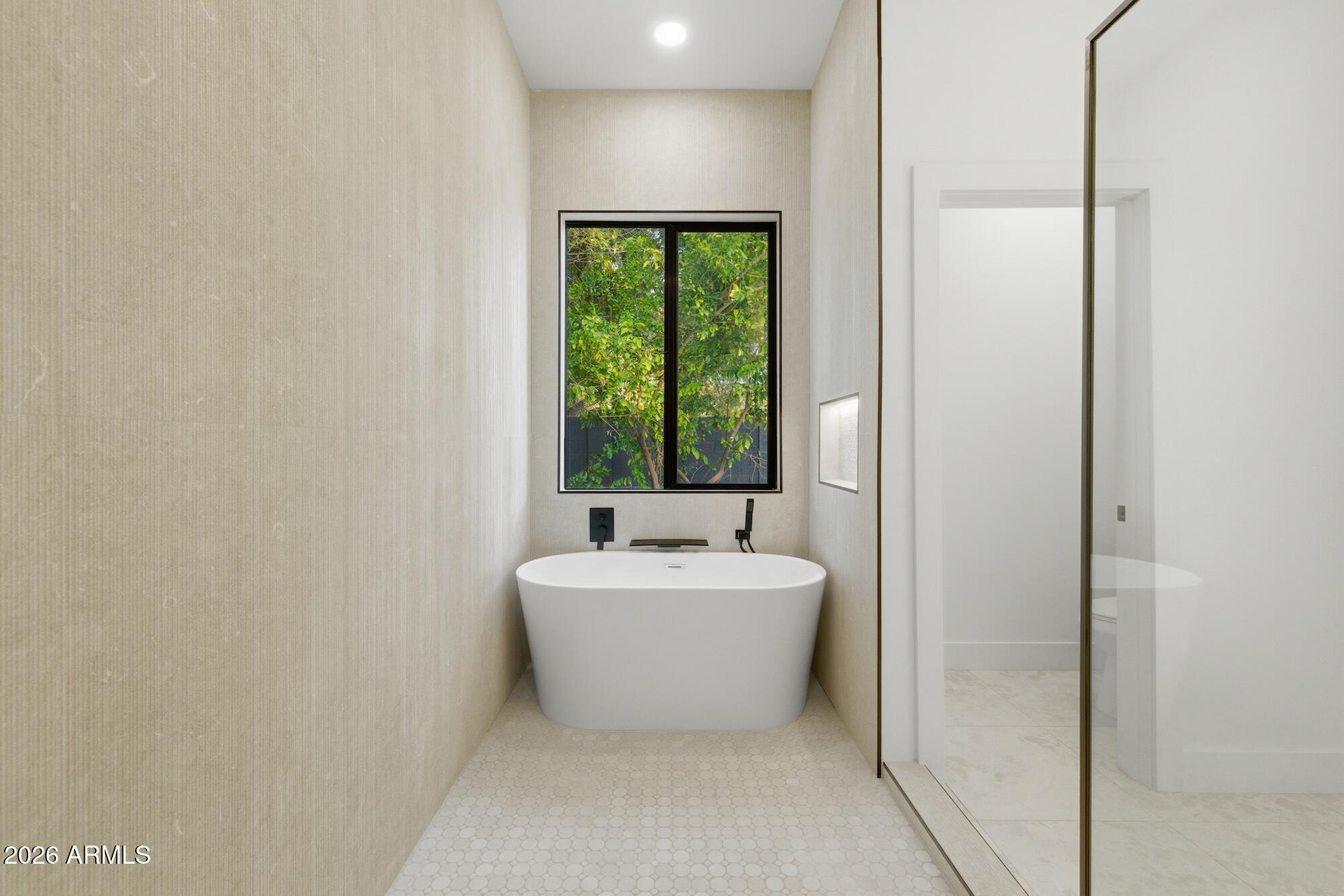 333 West Seldon Lane Phoenix, AZ 85021 - Photo 52 of 73 a bathroom with a bathtub and window