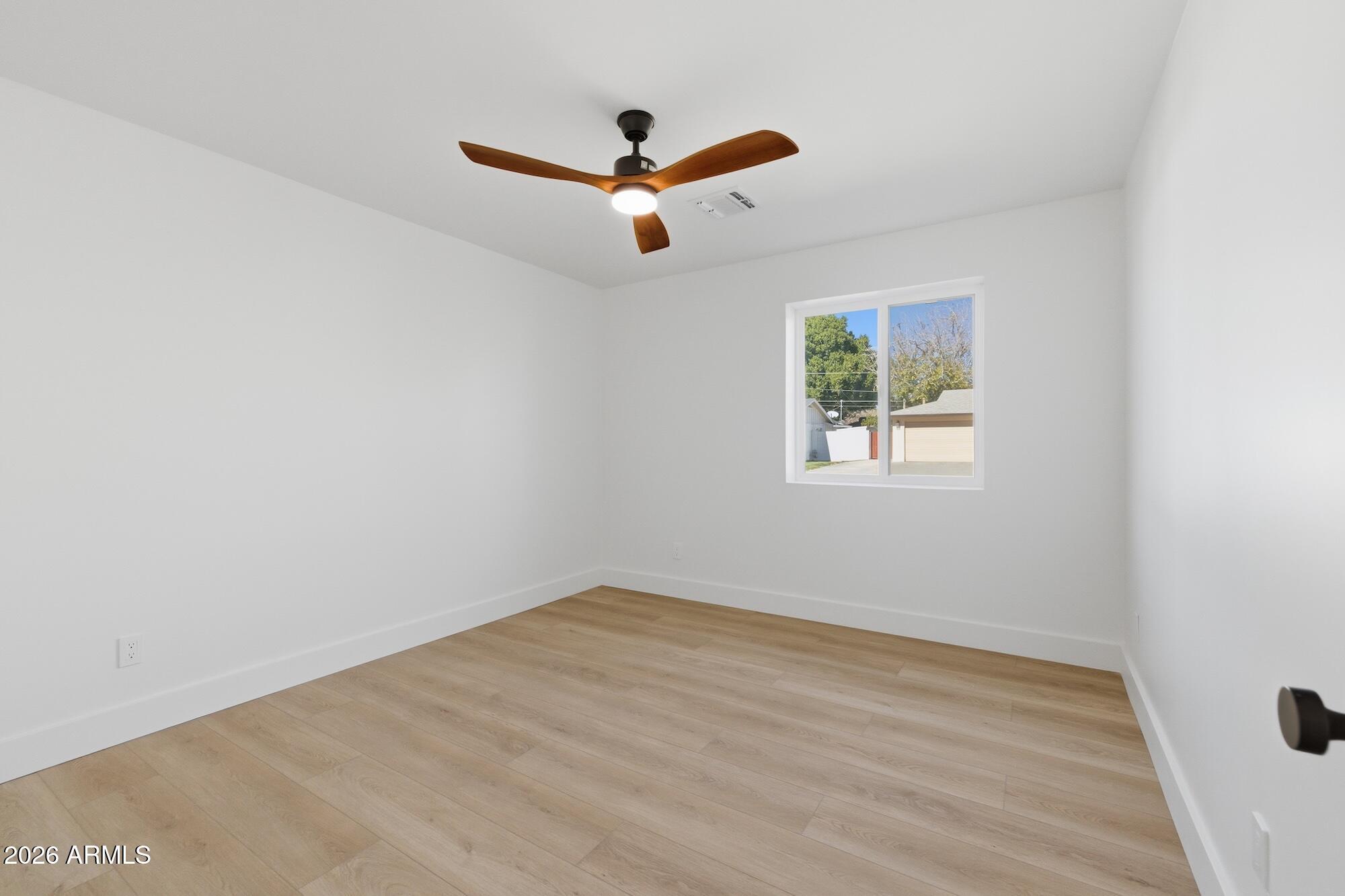 333 West Seldon Lane Phoenix, AZ 85021 - Photo 53 of 73 an empty room with wooden floor ceiling fan and window