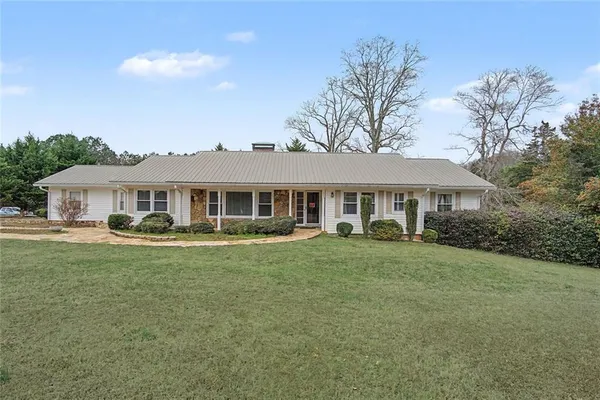a front view of a house with a garden