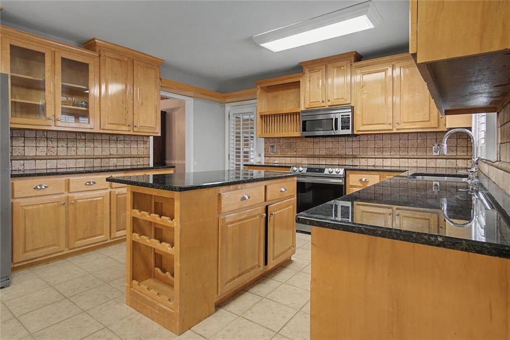 1001 Wiley Bridge Road Woodstock, GA 30188 - Photo 11 of 40 a kitchen with granite countertop a sink a stove and cabinets