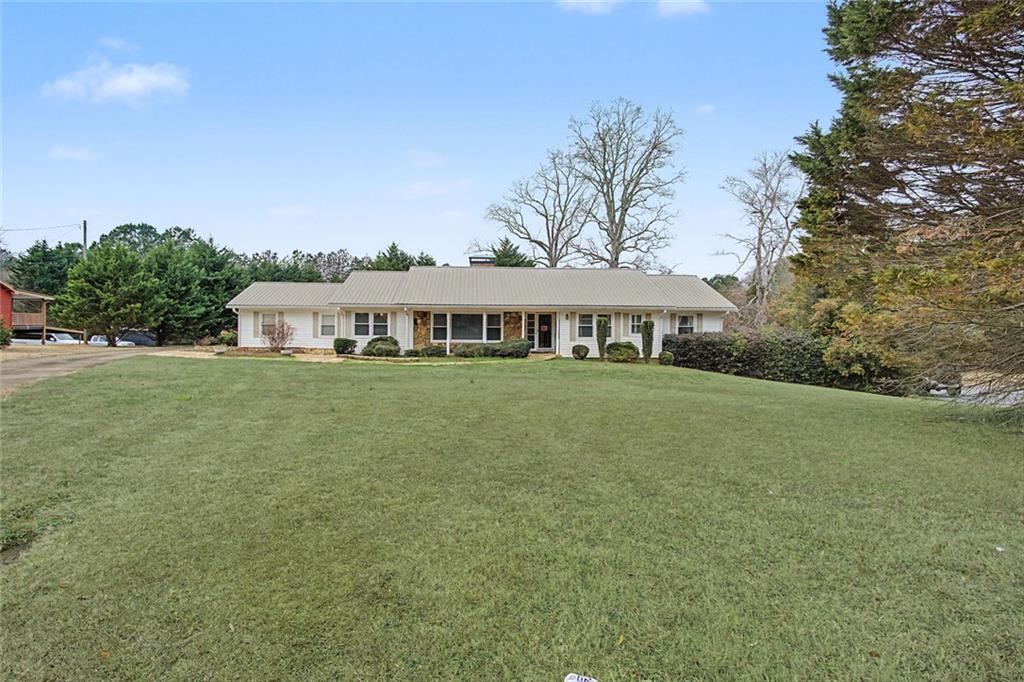 1001 Wiley Bridge Road Woodstock, GA 30188 - Photo 2 of 40 a front view of a house with garden