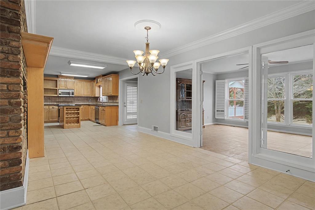 1001 Wiley Bridge Road Woodstock, GA 30188 - Photo 23 of 40 a view of a room with kitchen and chandelier