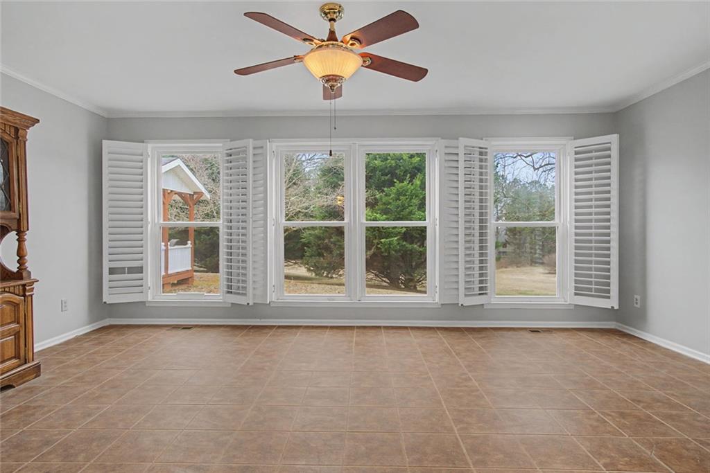 1001 Wiley Bridge Road Woodstock, GA 30188 - Photo 24 of 40 an empty room with a window and a ceiling fan