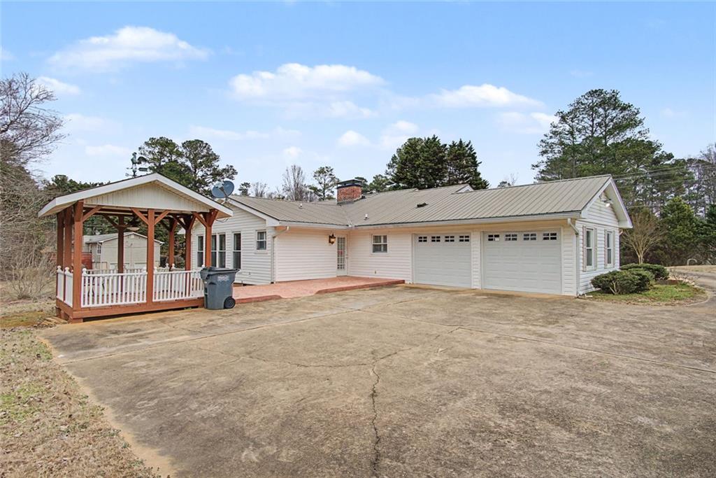 1001 Wiley Bridge Road Woodstock, GA 30188 - Photo 30 of 40 a view of a house with a yard and balcony