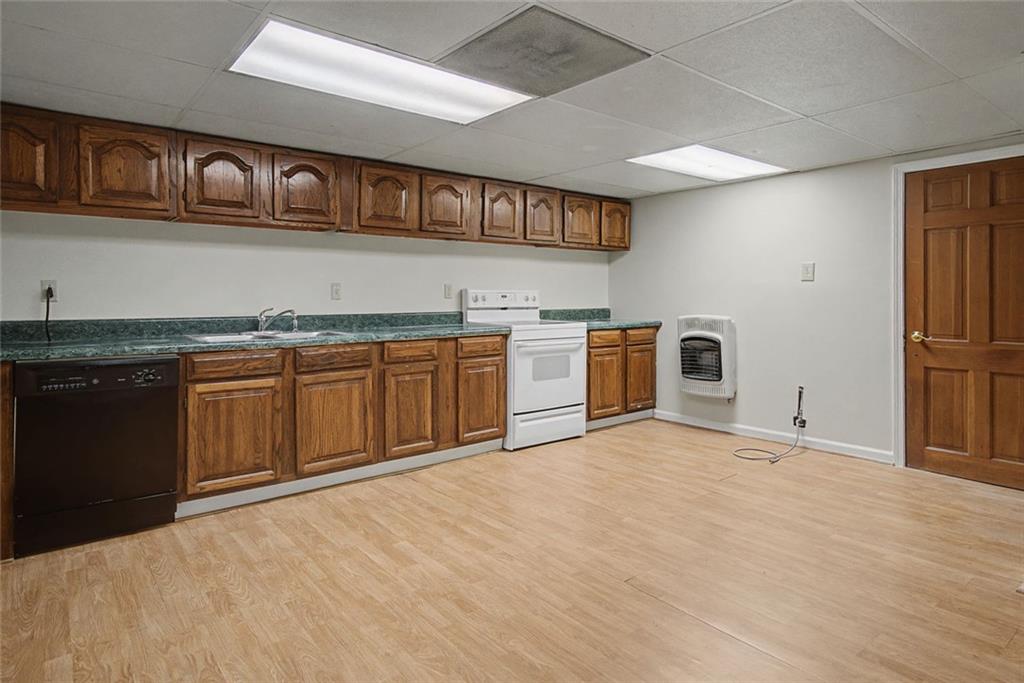 1001 Wiley Bridge Road Woodstock, GA 30188 - Photo 35 of 40 a kitchen with stainless steel appliances granite countertop a stove cabinets and wooden floor