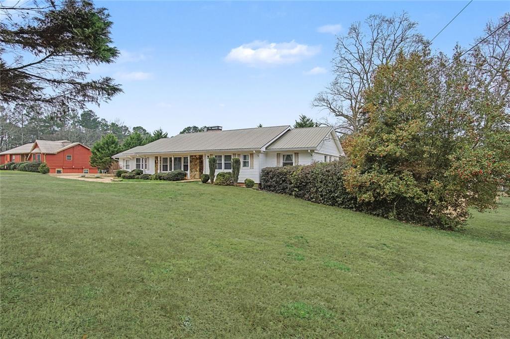 1001 Wiley Bridge Road Woodstock, GA 30188 - Photo 4 of 40 a view of a house with yard and sitting area