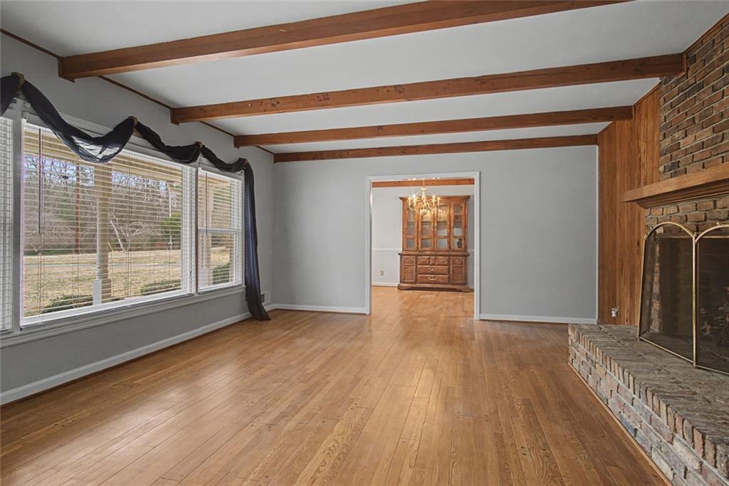 1001 Wiley Bridge Road Woodstock, GA 30188 - Photo 6 of 40 a view of an empty room with wooden floor and a window