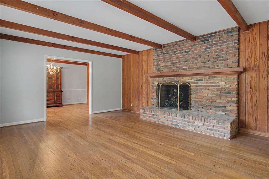 1001 Wiley Bridge Road Woodstock, GA 30188 - Photo 7 of 40 a view of a hallway with wooden floor and a fireplace