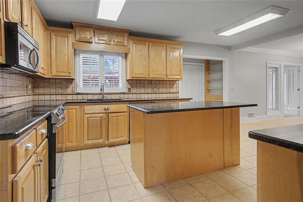 1001 Wiley Bridge Road Woodstock, GA 30188 - Photo 10 of 40 a kitchen with stainless steel appliances granite countertop a sink stove and cabinets