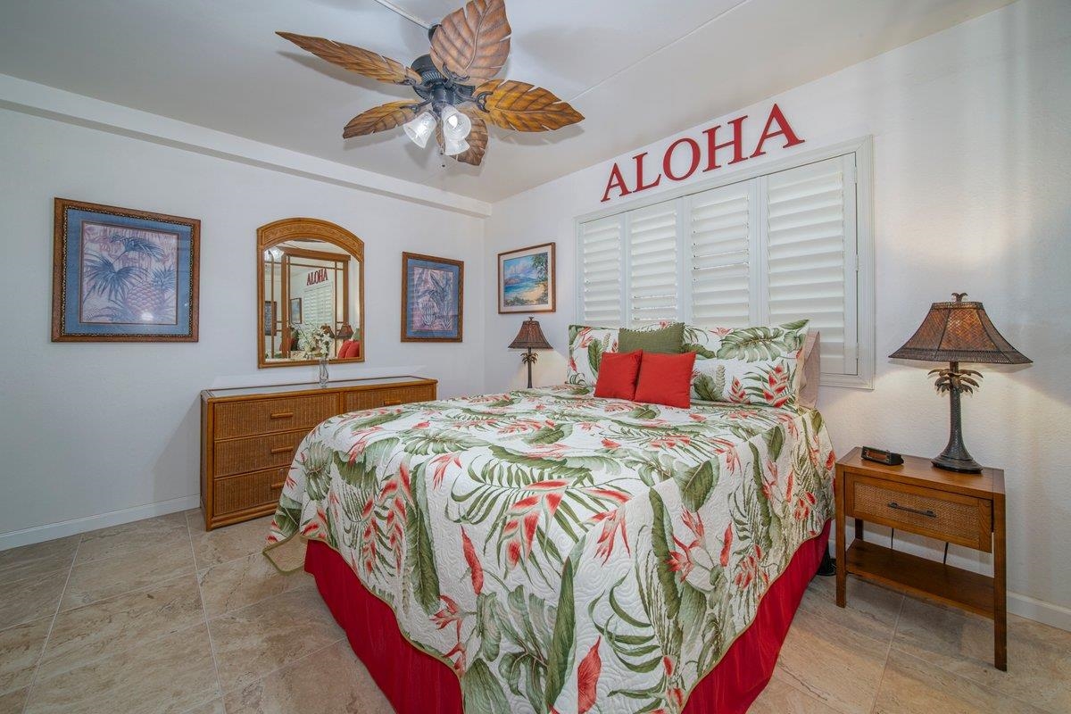 2387 South Kihei Road, Unit B303 Kihei, HI 96753 - Photo 13 of 48 a bedroom with a bed and a chandelier