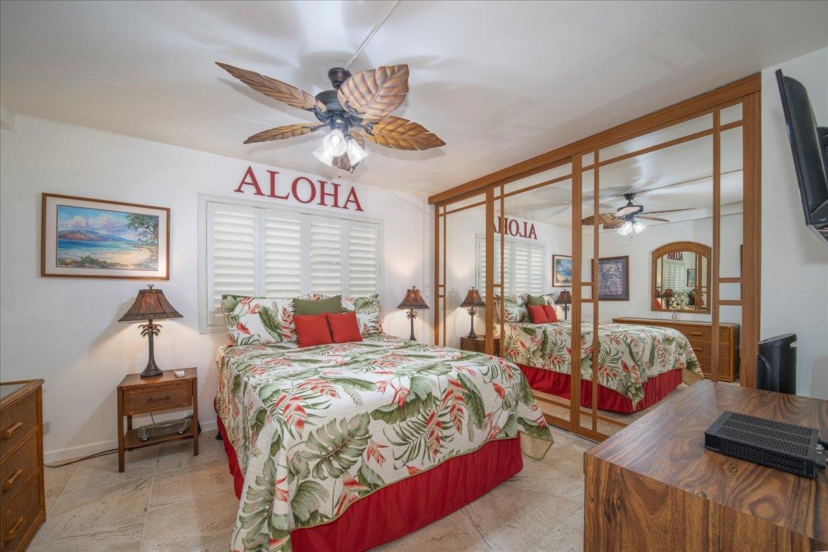 2387 South Kihei Road, Unit B303 Kihei, HI 96753 - Photo 14 of 48 a bedroom with a bed and a chandelier