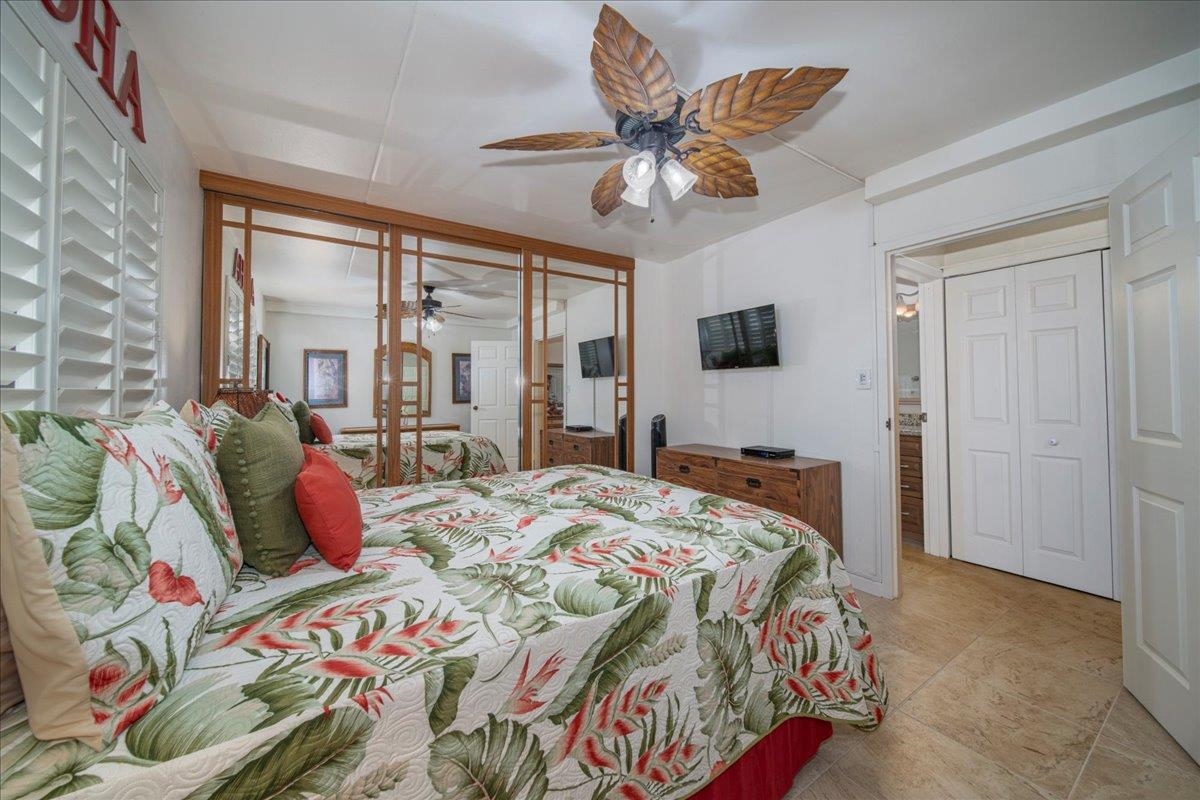 2387 South Kihei Road, Unit B303 Kihei, HI 96753 - Photo 15 of 48 a bedroom with a bed and a chandelier