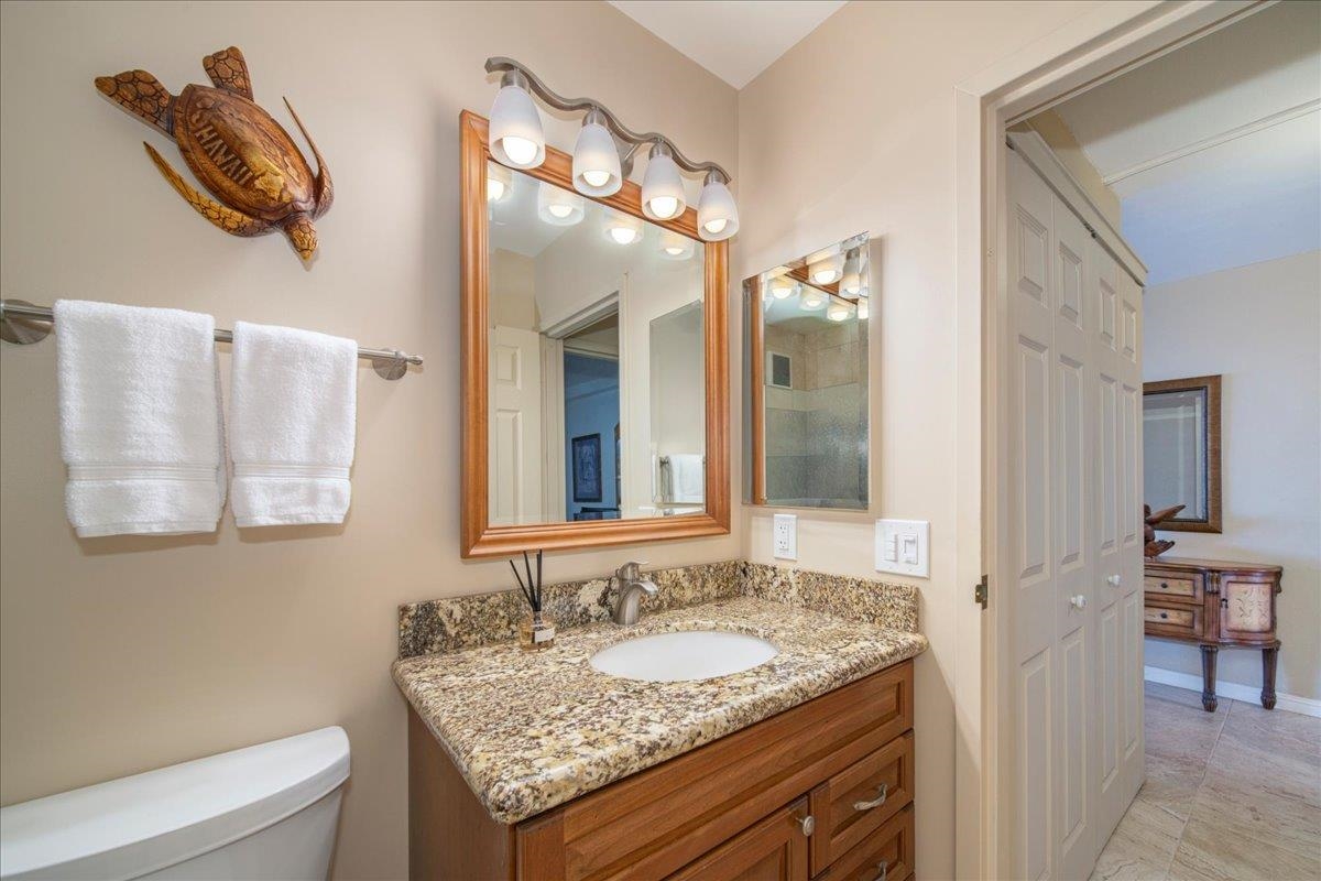 2387 South Kihei Road, Unit B303 Kihei, HI 96753 - Photo 16 of 48 a bathroom with a granite countertop sink and a mirror