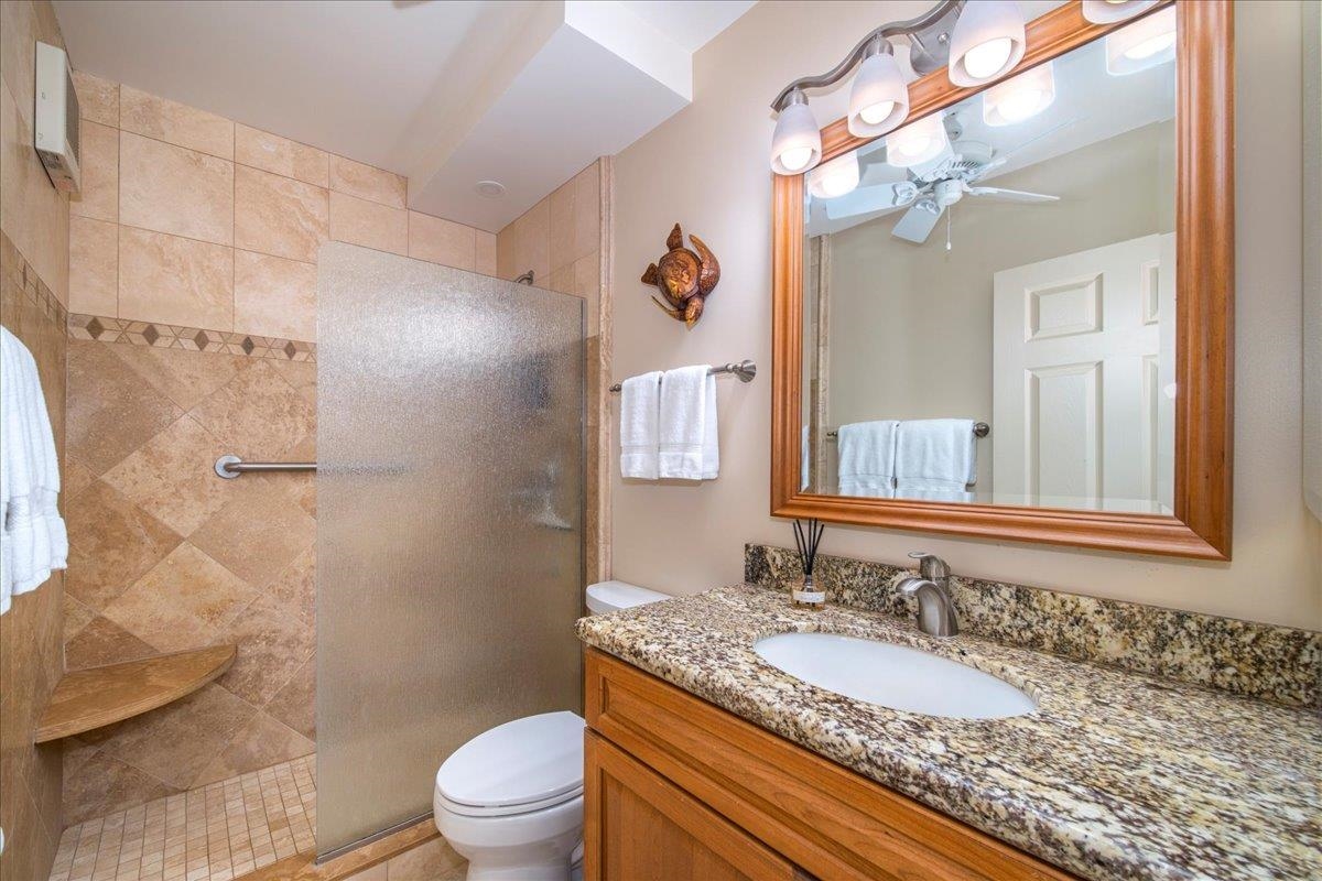 2387 South Kihei Road, Unit B303 Kihei, HI 96753 - Photo 17 of 48 a bathroom with a granite countertop sink toilet a mirror and shower