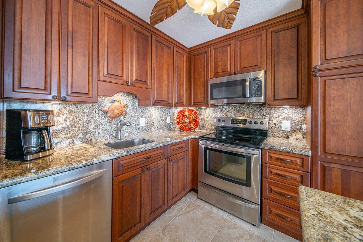 2387 South Kihei Road, Unit B303 Kihei, HI 96753 - Photo 2 of 48 a kitchen with stainless steel appliances granite countertop a sink stove and refrigerator
