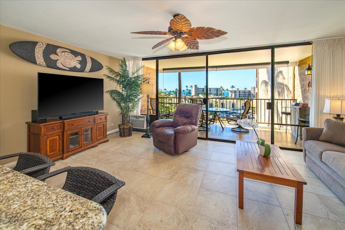 2387 South Kihei Road, Unit B303 Kihei, HI 96753 - Photo 23 of 48 a living room with furniture a flat screen tv and a large window