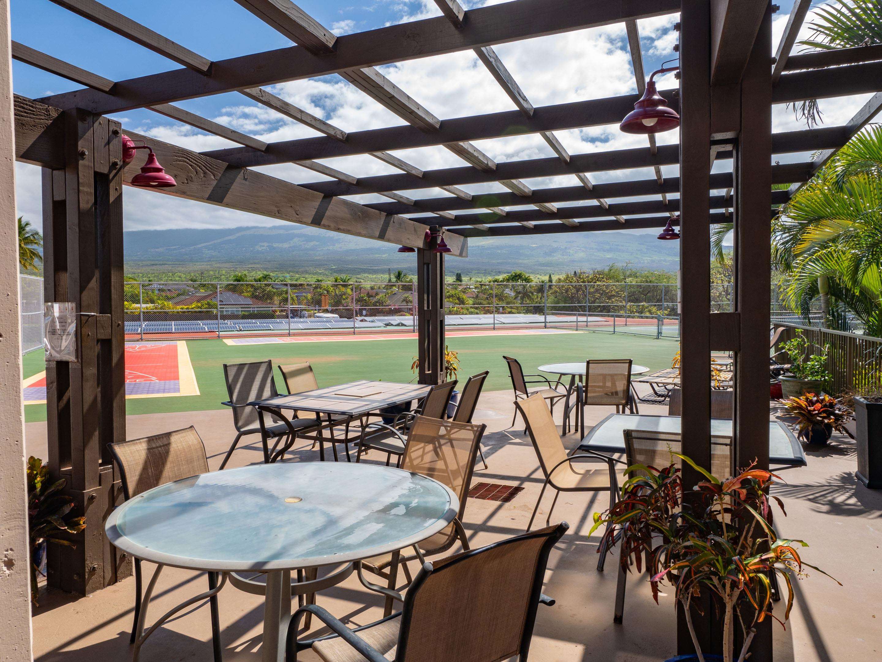 2387 South Kihei Road, Unit B303 Kihei, HI 96753 - Photo 36 of 48 a view of chairs and table in patio with a yard