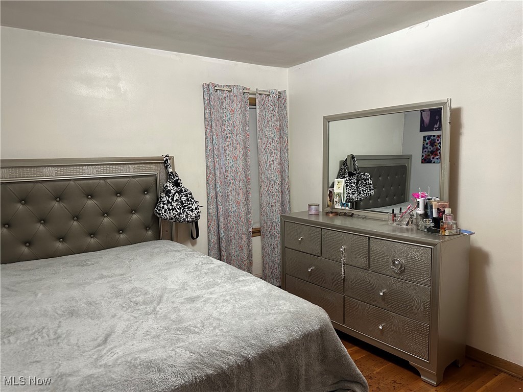 12303 Orme Road Garfield Heights, OH 44125 - Photo 18 of 22 Bedroom with dark wood-style flooring and baseboards