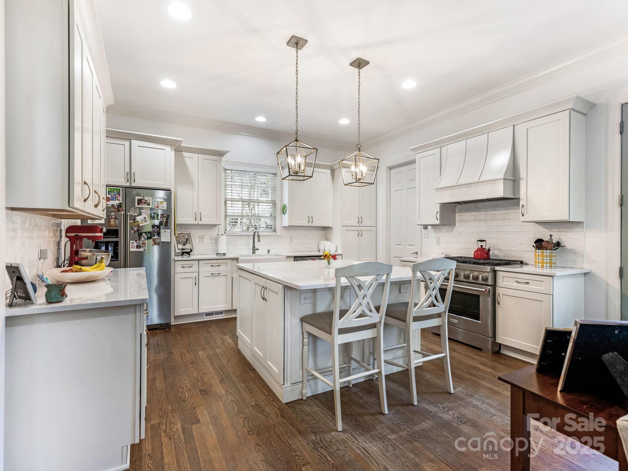 1110 Princeton Avenue Charlotte, NC 28209 - Photo 11 of 29 a kitchen with kitchen island granite countertop a table chairs sink and cabinets