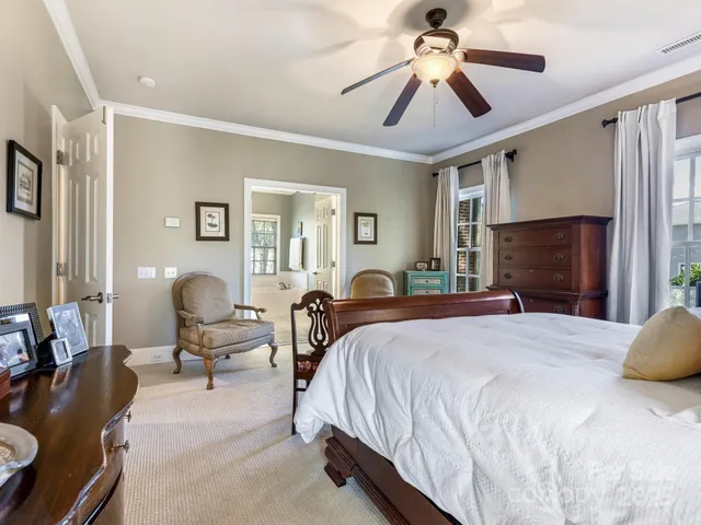 a spacious bedroom with a bed and ceiling fan