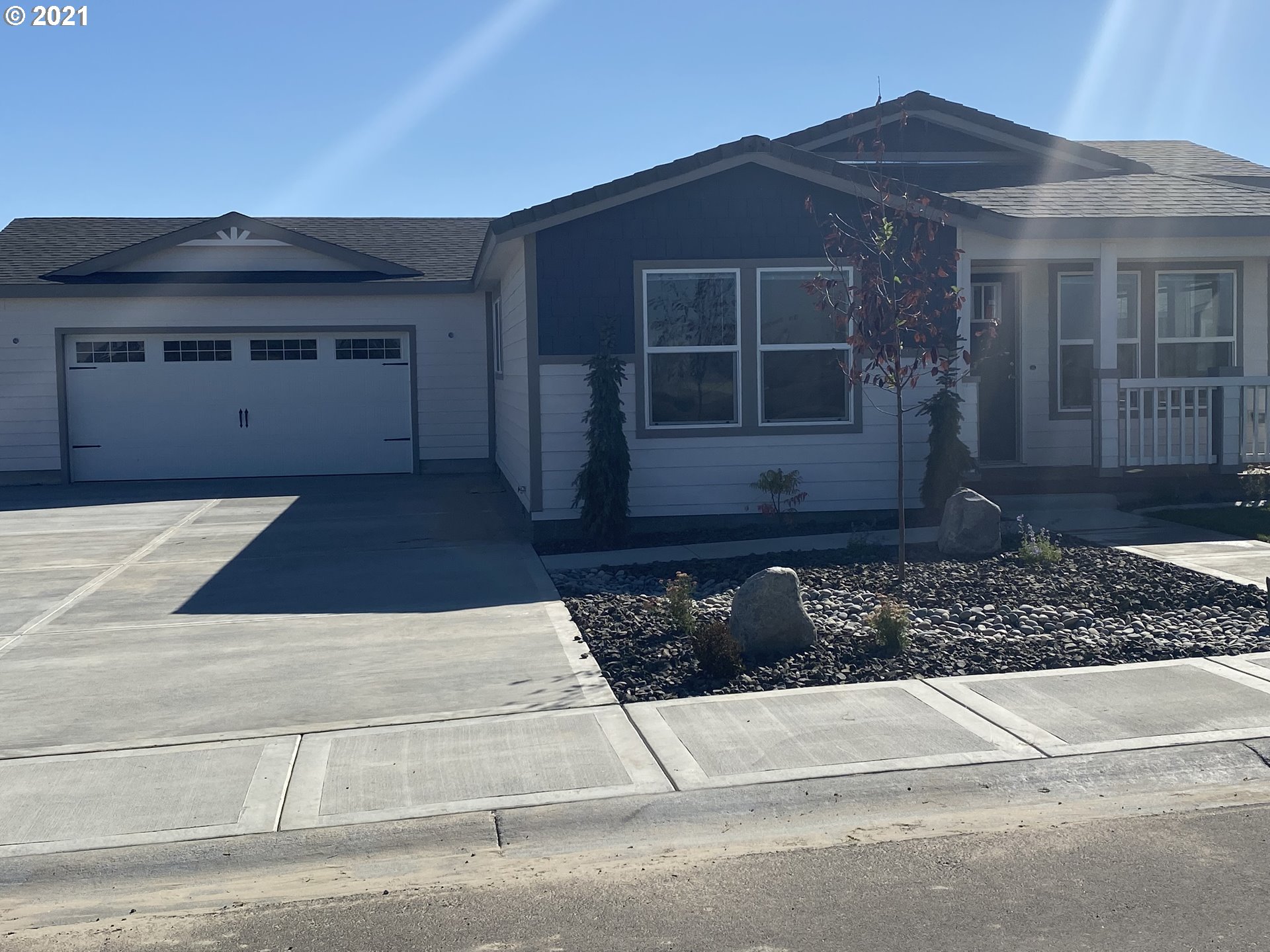 305 Oregon Trail Boulevard Boardman, OR 97818 - Photo 1 of 11 a front view of a house with a yard and garage