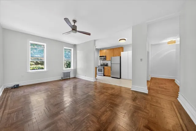 an empty room with windows and closet