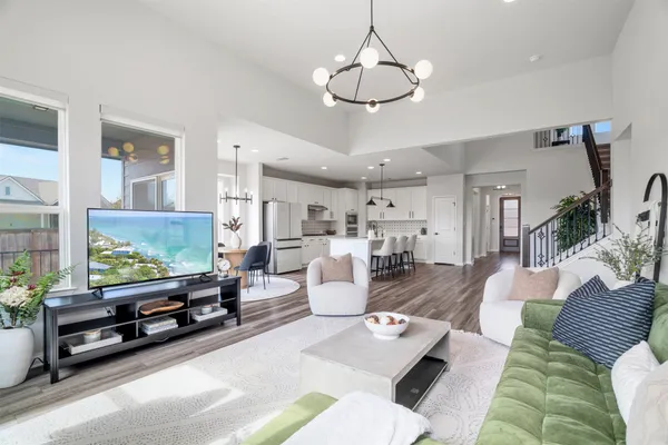 a living room with furniture a flat screen tv and a window