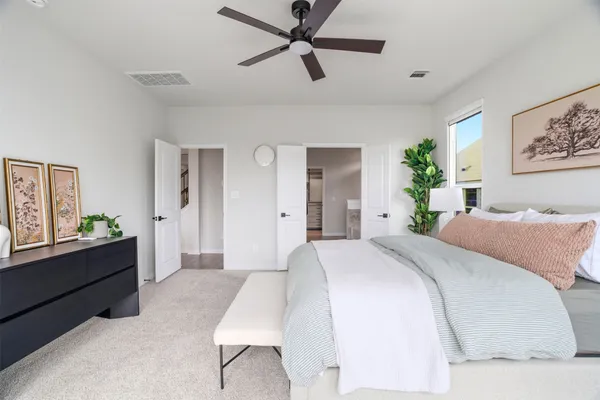 a spacious bedroom with a bed and a large window