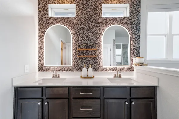a bathroom with a tub shower and sink