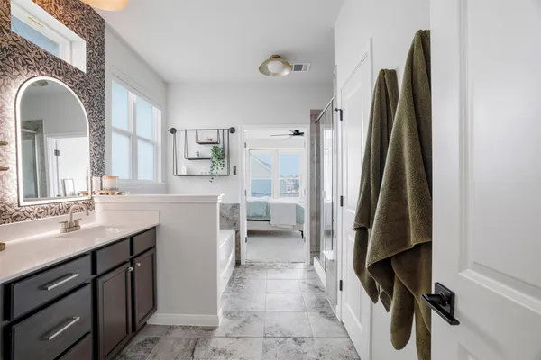 a bathroom with double vanity sinks and two mirror