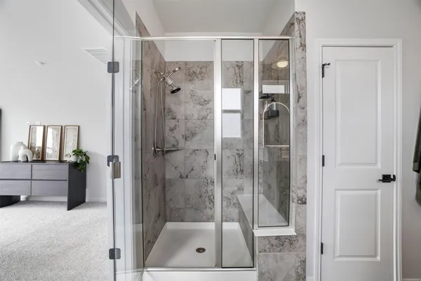a white bath tub sitting in a bathroom next to a window
