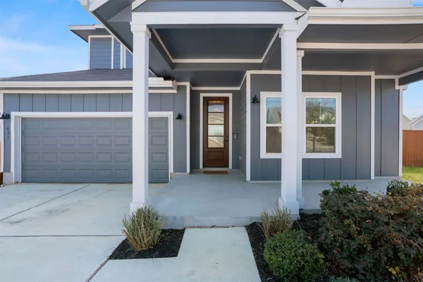 an open kitchen with wooden floor and stainless steel appliances
