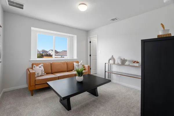 a spacious bedroom with a bed and a ceiling fan