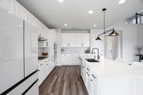 a white stove top oven sitting inside of a kitchen